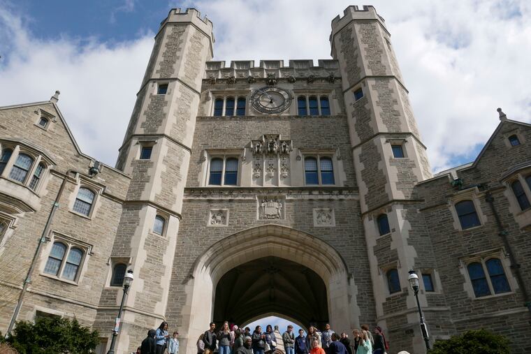 In this April 5, 2018 photo, people walk through the Princeton University campus.