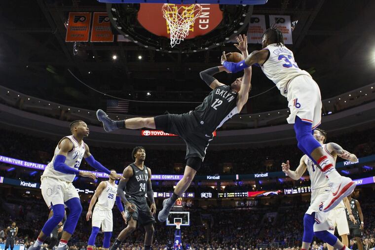 Robert Covington defends Joe Harris of the Nets during the Sixers win on Tuesday at Brooklyn.