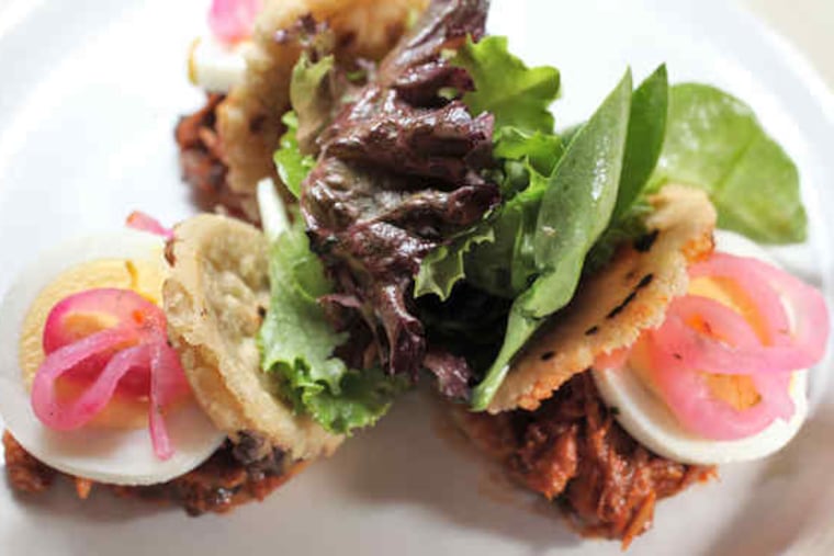 One of Jimenez' gorditas, open-faced with pork, sliced hard-cooked egg, and pickled onion.