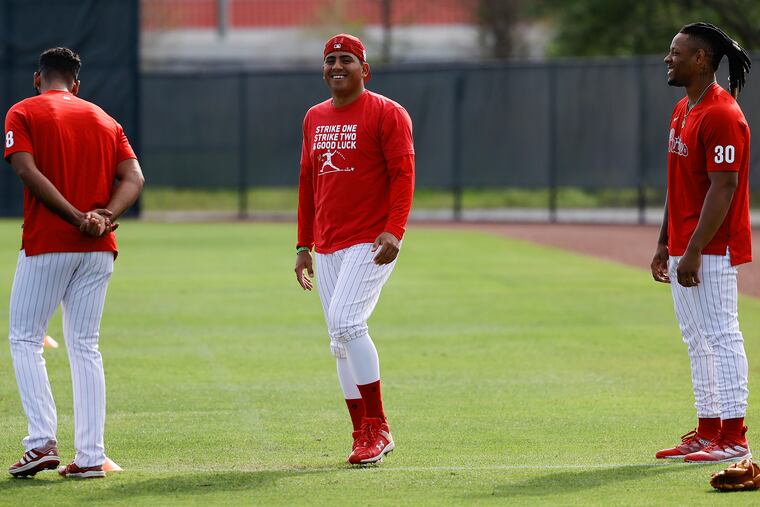 Phillies pitchers Ranger Suarez (center), Seranthony Dominguez (left) and Gregory Soto on the field Tuesday at the Carpenter Complex in Clearwater, Fla.