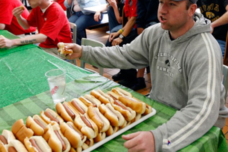 While the stretched stomach won't explode, it's still possible for a person to die from eating a massive meal. (AP Photo/The Hawk Eye, Matt Ryerson)