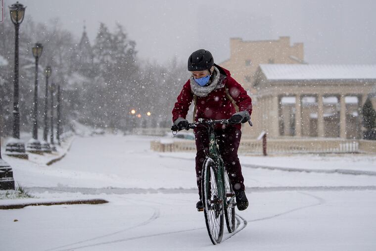 Dashing through the snow in a no-horse open bike, a cyclist rides near the Philadelphia Museum of Art, during a pre-Christmas snowfall in 2020, but it was gone by the 25th. Will snow be on the ground this Christmas?