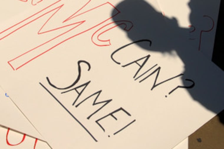 As McCain spoke , an Obama backer casta shadow over an anti-McCain sign. But many said McCain impressed them.