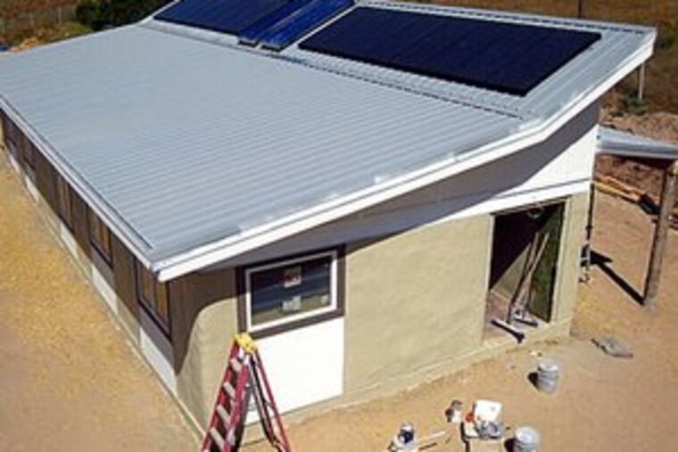 The straw-bale house in Montana, with photovoltaic array, was built for $109,000. Its design had to both reflect Cheyenne values and be easy enough for anyone to build affordably.