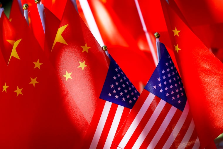 American flags are displayed with Chinese flags in Beijing in 2018.