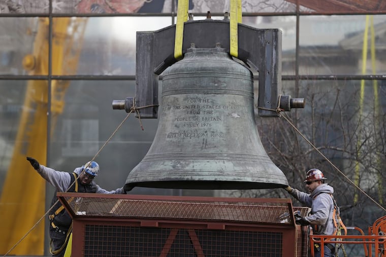 FILE – In this Jan. 31, 2013, file photo, workmen guide the Bicentennial Bell, a gift from Britain for America’s 200th birthday in 1976, before it is lifted into a shipping container in Philadelphia.