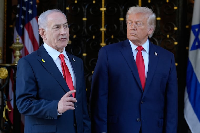 President Donald Trump listens as Israel's Prime Minister Benjamin Netanyahu speaks during arrival at his Mar-a-Lago club, Monday, Dec. 29, 2025, in Palm Beach, Fla.