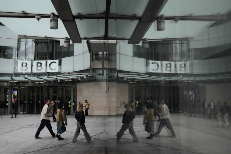 FILE - Pedestrians are reflected as they walk outside BBC Broadcasting House in London, Tuesday, Nov. 11, 2025. (AP Photo/Kirsty Wigglesworth, file)