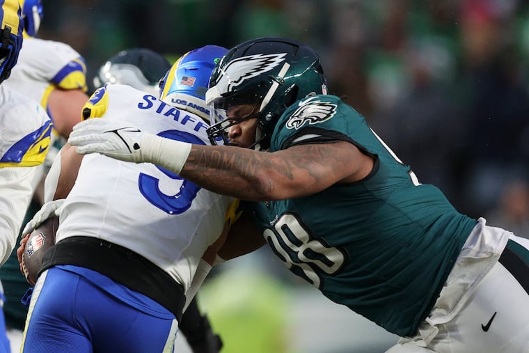 Eagles defensive tackle Jalen Carter wraps up Rams quarterback Matthew Stafford. Carter notched the key sack in the closing seconds.