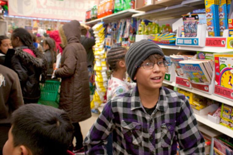 Irving Lopez, 9, participates in a shopping spree at a Dollar Tree store. (Ed Hille / Staff Photographer)