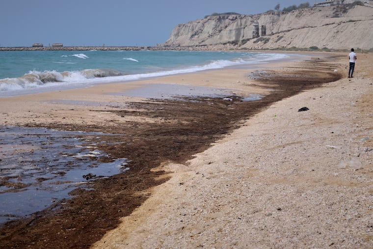 Dark oil residue covers parts of the shoreline at Shib Deraz Beach on Qeshm Island, Iran, Thursday, Aug. 13, 2026, amid ongoing wartime attacks on vessels and infrastructure in and around the Strait of Hormuz, though the spill’s source has not been independently determined.