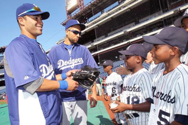 Dodgers' Jerry Hairston Jr. (left) and teammate James Loney talk with Anderson Monarchs players, who visited Citizens Bank Park for recent game