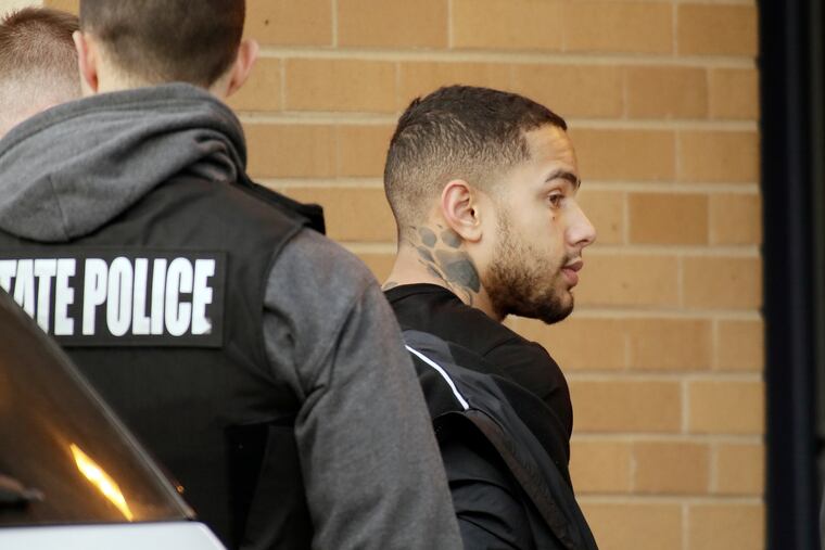 State troopers escort the handcuffed shooting suspect from Salem, N.J., on Wednesday, Jan. 23, 2019, to the Woodstown Barracks. (Elizabeth Robertson / Staff Photographer)