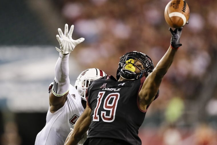 Temple wide receiver Ventell Bryant attempts to catch a pass while defended by UMass cornerback Lee Moses on Sept. 15.