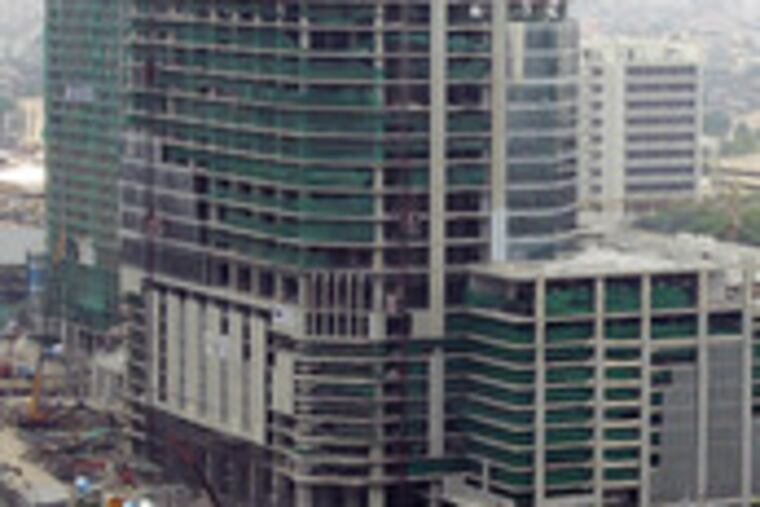 An office tower in Bangkok, Thailand, was left half-built for years because of the '97 Asian financial crisis. As that event's 10th anniversary approaches, economists reflect on how to avert a repeat. C2.