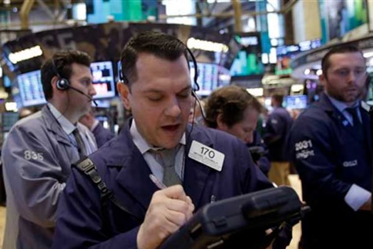 Traders work on the floor at the New York Stock Exchange in New York, Tuesday, Feb. 19, 2013. Talk of more mergers and acquisitions is sending stock prices slightly higher in early trading, setting the market up to continue a seven-week rally. (AP Photo/Seth Wenig)