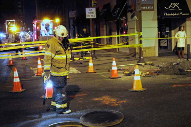 Residents of Oakwood Apartments in Center City Philadelphia were evacuated to entrance lobby of Liberty Place at 16th and Chestnut St. after an underground transformer blew, causing a gas leak. morning January 2, 2012. A member of the fire department is seen here investigating the scene. ( ALEJANDRO A. ALVAREZ / STAFF PHOTOGRAPHER )