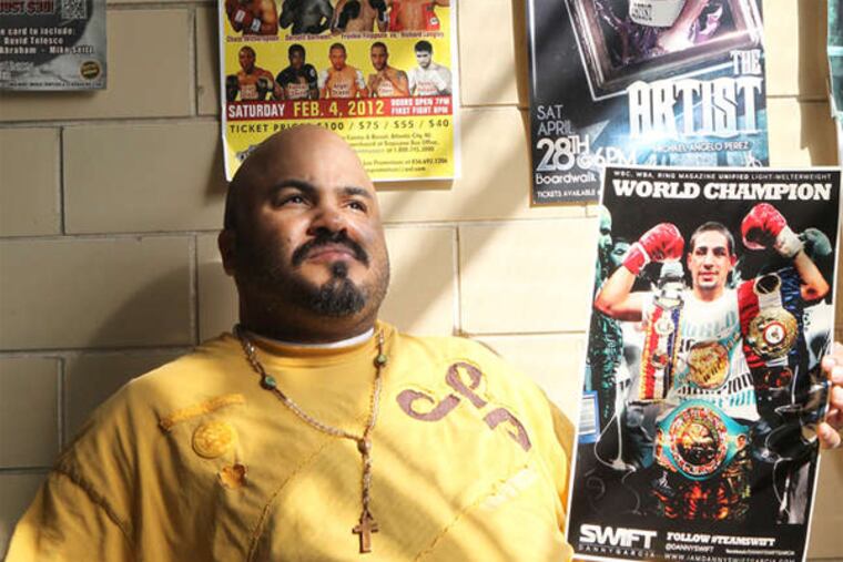 Humberto Perez holds a poster of Danny Garcia, the world light-welterweight boxing champion.