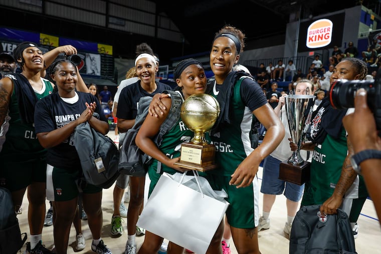 Ashley Jones (left) and Azana Davies hold the MVP trophy after Team Copper beat Team Harper, 62-61, in overtime to win the Danny Rumph Classic women's final on Sunday.