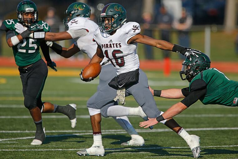 Cedar Creek's Bo Melton, #16, center, pushes away West Deptford's #11, Nick Diaco, right, as he carries the ball down on the last play of the first half. He was tackled at the 1 as time expired.