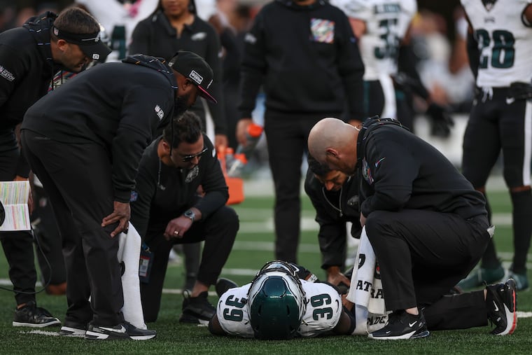 Injured Eagles cornerback Eli Ricks is checked on during the loss to the Jets at MetLife Stadium.