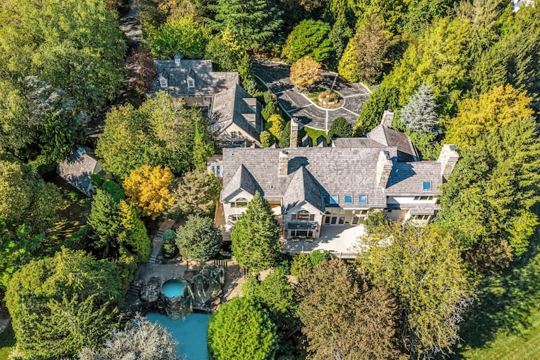 The property for sale for $8.5 million in Gladwyne includes a 9,166-square-foot home, two oversized two-car garages, terraces, a pool, and a cottage-like utility building.