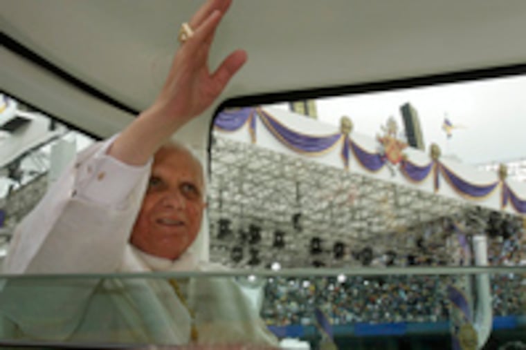 Pope Benedict XVI greets the crowd as he enters Yankee Stadium in New York to celebrate Mass. The pontiff began the day with a visit to ground zero, the site of the World Trade Center attacks of Sept. 11, 2001, where he offered prayers.