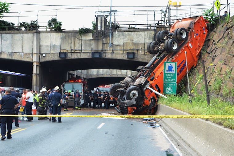 First responders work the scene of a truck accident in Union, City, N.J., not far from the Lincoln Tunnel, Wednesday, July 3, 2019. (Michaelangelo Conte / Jersey Journal via AP)