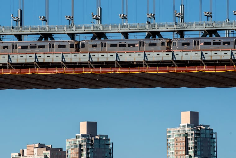 A PATCO Speedline train crosses the Ben Franklin Bridge.