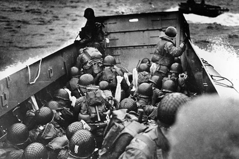 A U.S. Coast Guard landing barge, tightly packed with helmeted soldiers, approaches the shore at Normandy, France, during initial Allied landing operations, June 6, 1944. These barges ride back and forth across the English Channel, bringing wave after wave of reinforcement troops to the Allied beachheads. (AP Photo)