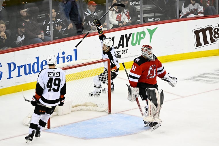 New Jersey Devils goaltender Vitek Vanecek reacts as Flyers right wing Travis Konecny celebrates his goal with left wing Noah Cates.