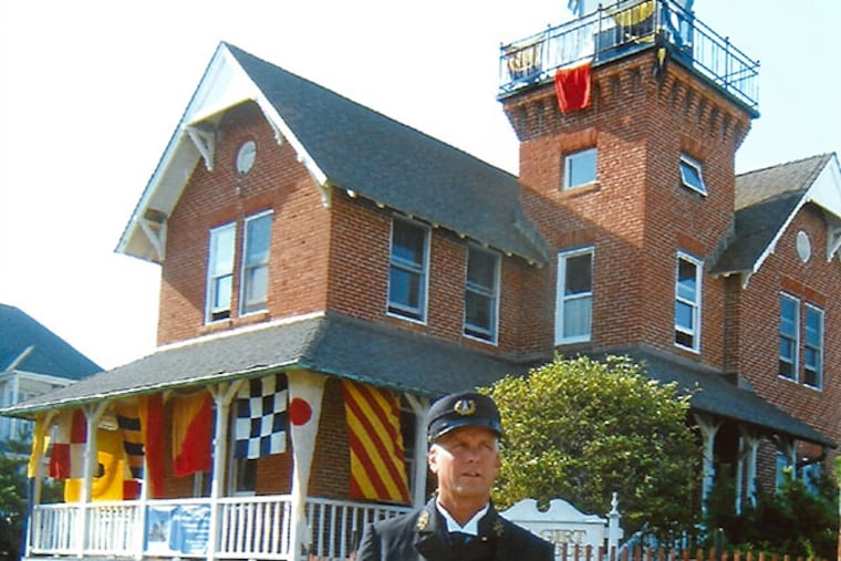 Jude Meehan, vice president of the Sea Girt Lighthouse Citizens Committee, dons the 1912- style keeper's uniform. BILL DUNN / For The Inquirer