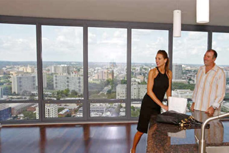 Jill and Michael Williams in their new one-bedroom condo. Listed for $780,000, the unit is theirs for $513,000. (Michael S. Wirtz / Staff Photographer)