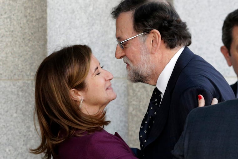 Former Spanish Prime Minister Mariano Rajoy is received by prosecutor Ana Murillo, as he arrives at the court to the testify in the ongoing trial of Catalan separatists in Madrid, Spain, Wednesday, Feb. 27, 2019. (AP Photo/Andrea Comas)