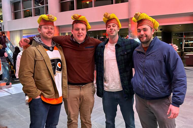 Xander Utecht (from left), Miles Macaleer, Cole Harper, and Brad Allan at the Wells Fargo Center Monday for the Flyers' Dollar Dog Night against the St. Louis Blues.