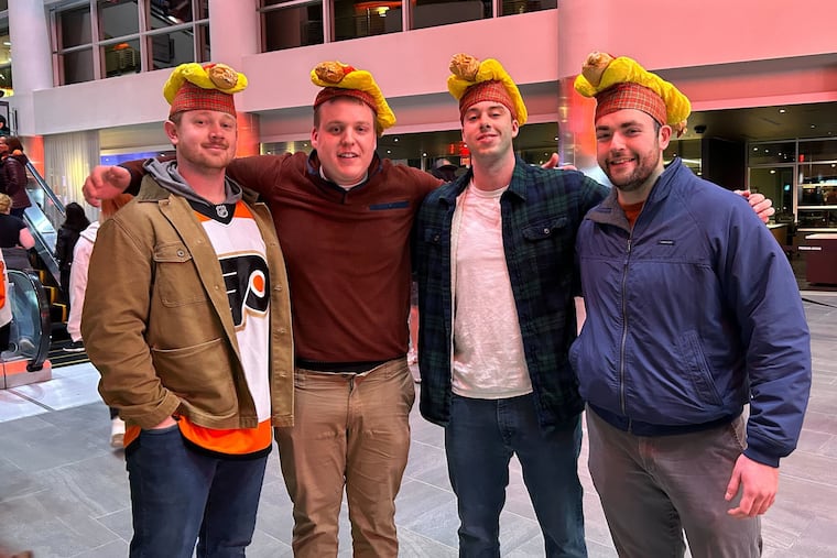 Xander Utecht (from left), Miles Macaleer, Cole Harper, and Brad Allan at the Wells Fargo Center Monday for the Flyers' Dollar Dog Night against the St. Louis Blues.