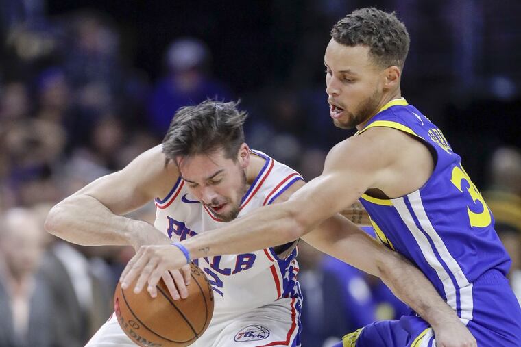Golden State Warriors guard Stephen Curry pressures Sixers guard T.J. McConnell during the third-quarter on Saturday, November 18, 2017 in Philadelphia. YONG KIM / Staff Photographer