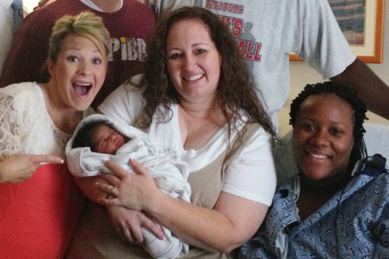 Shannin Danquah (right) of Aston, Pa., gave birth in Atlanta the day her family competed on an episode of "Family Feud." With her are two women from the Allen family, who were also on the show. The show was set to air on the CW in Philadelphia on Feb. 13, 2014.