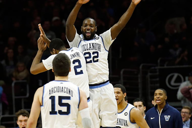 Villanova's JayVaughn Pinkston (right) leaps with teammate Kris Jenkins (center) with Ryan Arcidiacono walking to the bench. (Yong Kim/Staff Photographer)