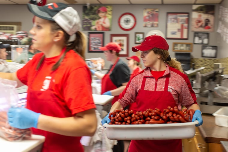 Marley Mikovich, an employee, carries a tray of kielbasy at Kowalonek's Kielbasy Shop in Shenandoah PA, Schuylkill County, Saturday, April 6, 2019. The Kielbasy attracts customers from across the state and even South of PA in Virginia and Maryland.