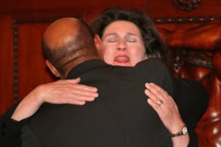 Mayor Nutter gives Camille Cates Barnett a hug before her swearing-in as Philadelphia managing director. Her husband died this month, delaying the ceremony at City Hall. B6.