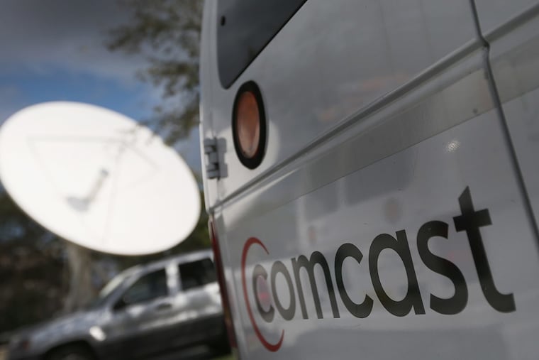 A Comcast truck parked at one of the system's headends, the hubs from which broadband internet and cable service is distributed to customers. Comcast on Monday pledged to double its network energy efficiency by 2030.
