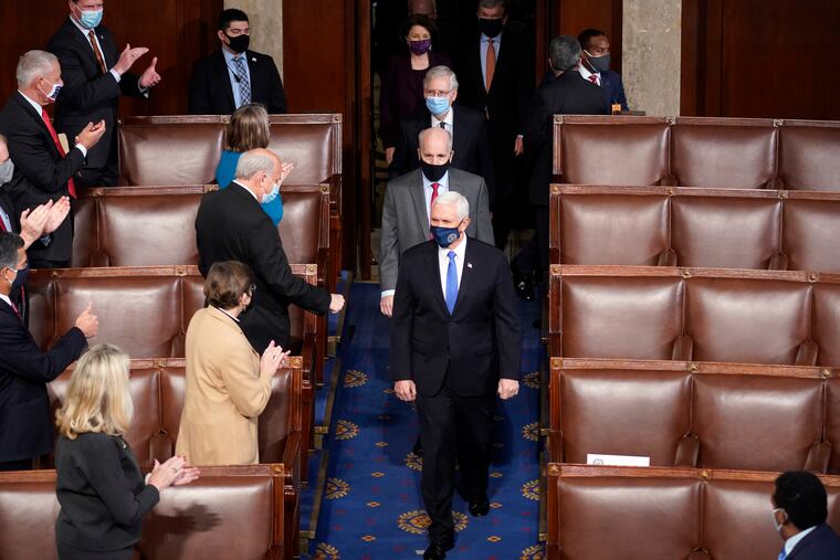 Vice President Mike Pence (middle, front) arrives with members of the Senate to officiate as a joint session of the House and Senate convened to count the electoral votes cast in November's election, at the Capitol on Wednesday.