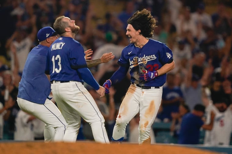 Los Angeles Dodgers' James Outman, right, celebrates with Max Muncy (13) after Outman drove in the winning run with a double against the the Toronto Blue Jays during the 10th inning of a baseball game Tuesday, July 25, 2023, in Los Angeles. (AP Photo/Ryan Sun)