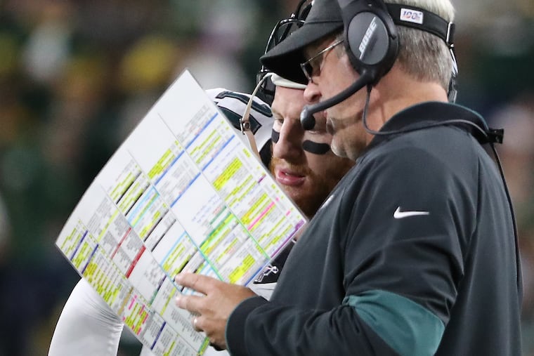 Eagles quarterback Carson Wentz and coach Doug Pederson talk during the Packers game.