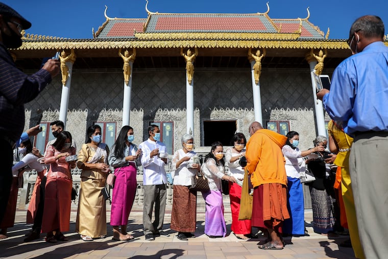 People make offerings of rice and money to the monks during the Kathina Ceremony at Wat Khmer Palelai in Philadelphia, Pa. on Sunday, Oct. 4, 2020. The temple will be the site of one of many Cambodian New Year celebrations this year.