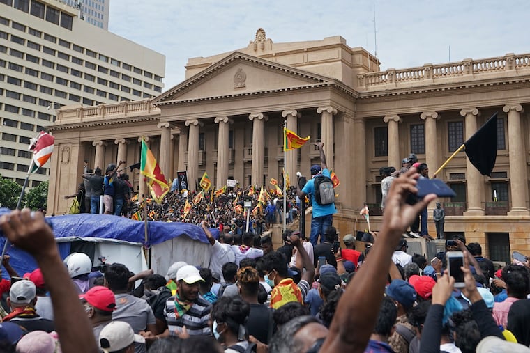 Protesters, many carrying Sri Lankan flags, gather outside the presidents office in Colombo, Sri Lanka, on Saturday.