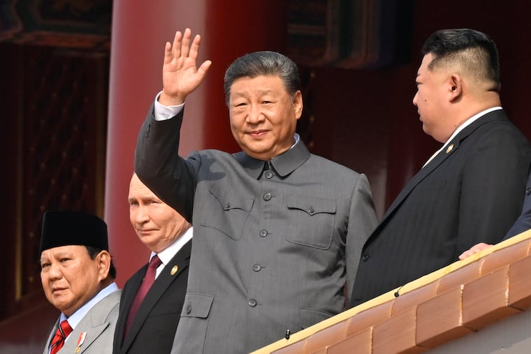 Chinese President Xi Jinping waves during a military parade at Tiananmen Square in Beijing on Sept. 3 marking the 80th anniversary of the end of World War II. Indonesian President Prabowo Subianto (from left), Russian President Vladimir Putin, and North Korean leader Kim Jong Un joined him.