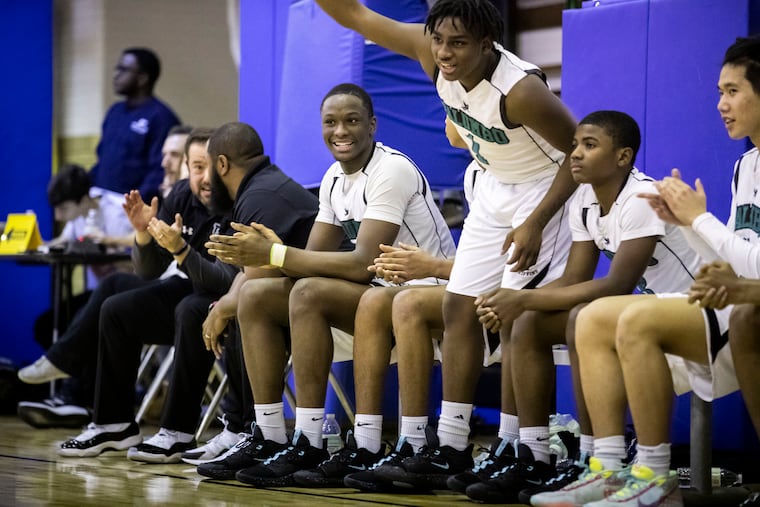 In this January, 2020 file photo, members of the Academy at Palumbo boys' basketball team cheer for their teammates during a game.