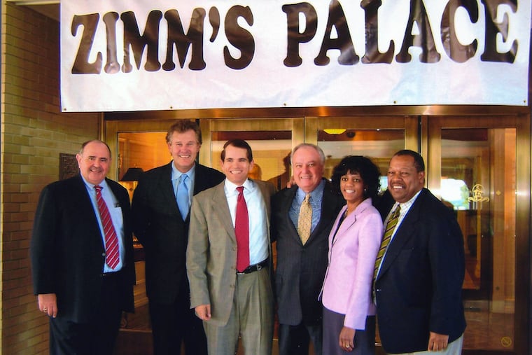 A custom-made banner is draped over the hotel’s entrance, directed at Hershey Trust Chairman LeRoy S. Zimmerman. The trustees (from left): James Mead, Joseph M. Sensor, Robert Cavanaugh, Zimmerman, Velma A. Redmond and James Nevels.